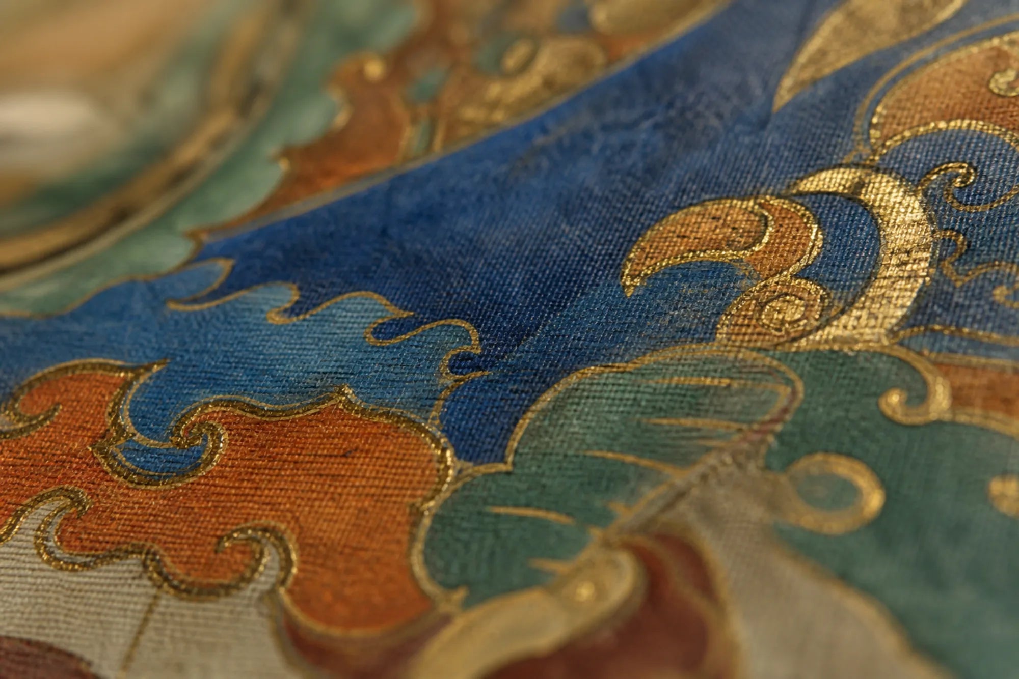 Mineral pigment and gold on sized cotton, seen close